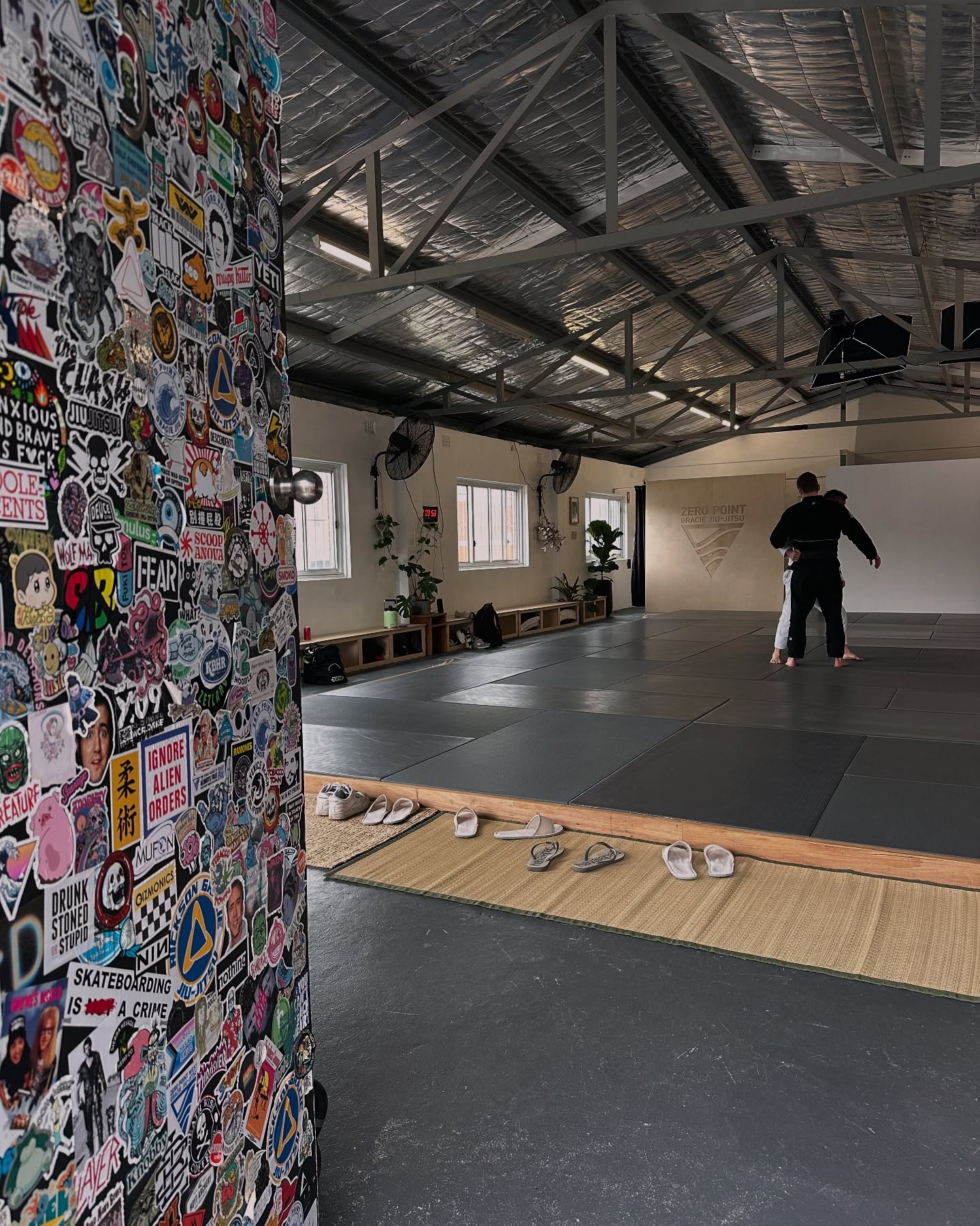 The training mats and sticker wall inside Zero Point Sydney